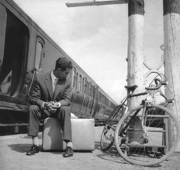 Federico Bahamontes sitting next to his bike at a train station in 1960