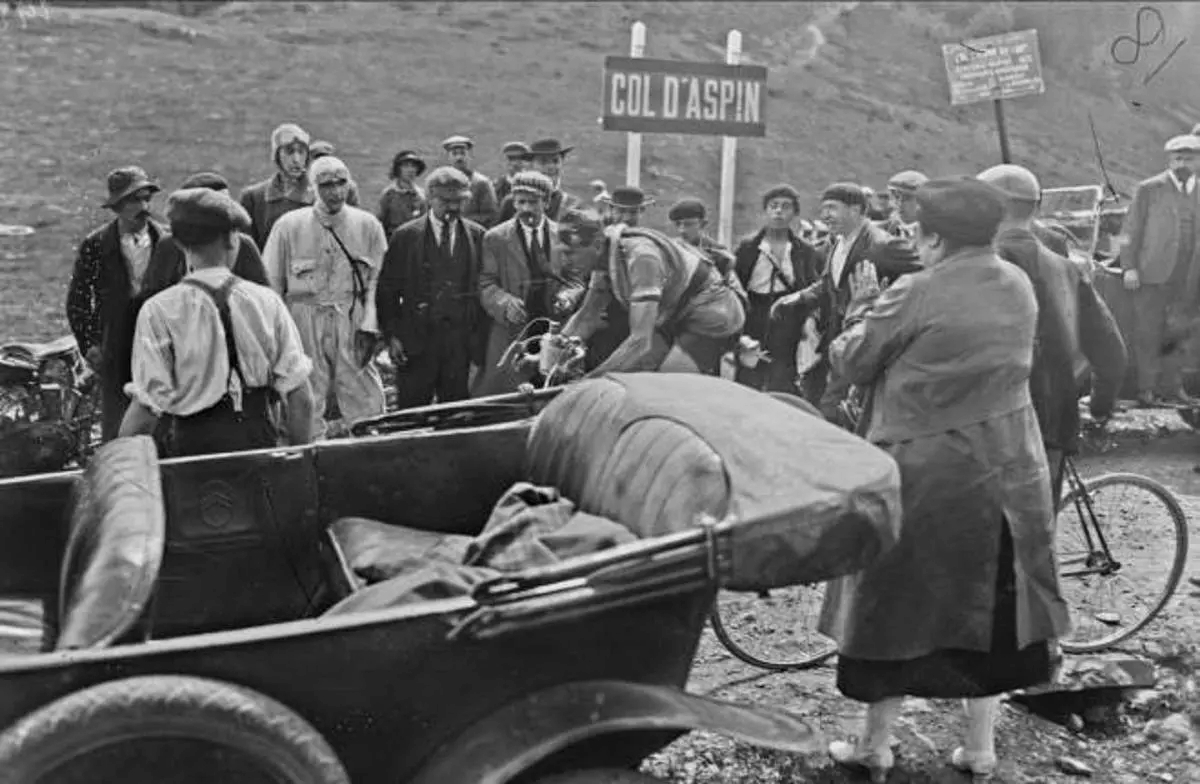 Crowd of spectators of the cycling race Tour de France are cheereing for the French rider Jean Alavoine while climbing Col d'Aspin in 1922