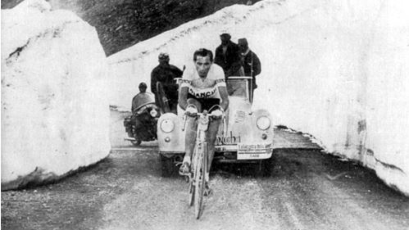 Italian cycling legend Fausto Coppi riding between two big snow walls on Stelvio in 1952