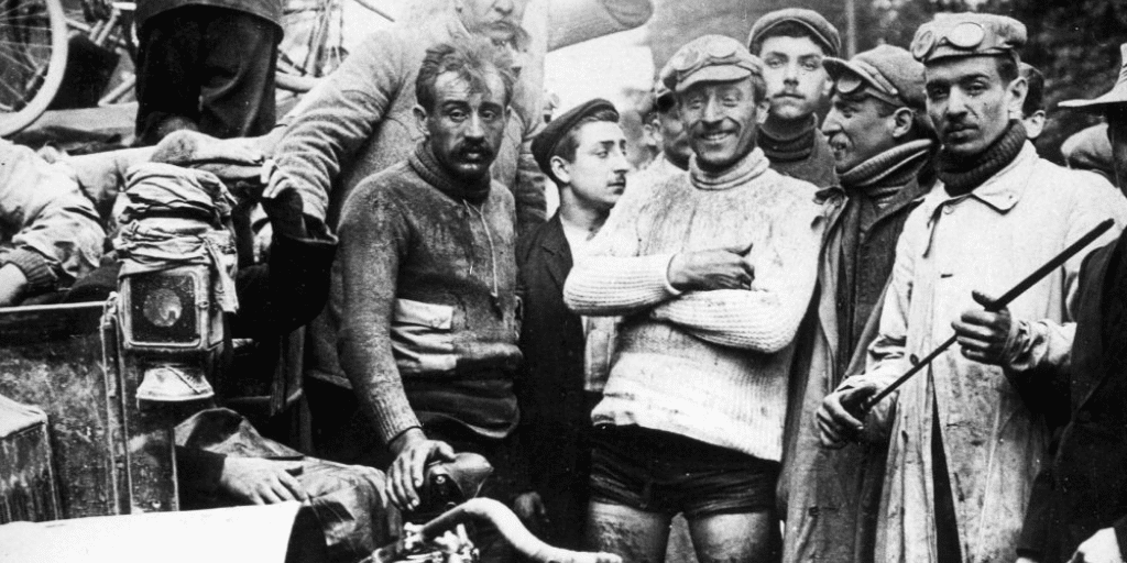 French winner Maurice Garin and other cyclists looking into the camera at the Tour de France 1903