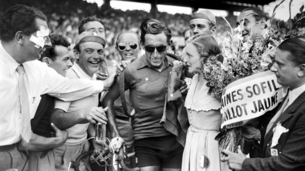 Famous picture of Fausto Coppi with sun glasses celebrating his Tour de France victory in 1949