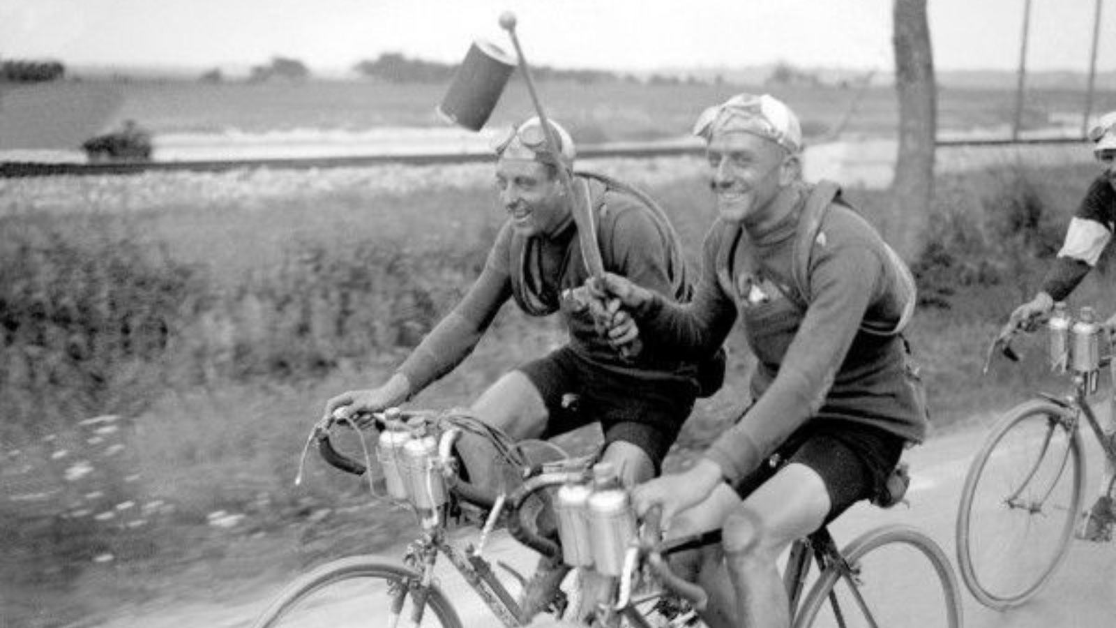 Vintage cycling image from the 1920s, two cyclists with the socalled laterne rouge, the prize for the last placed rider of the race