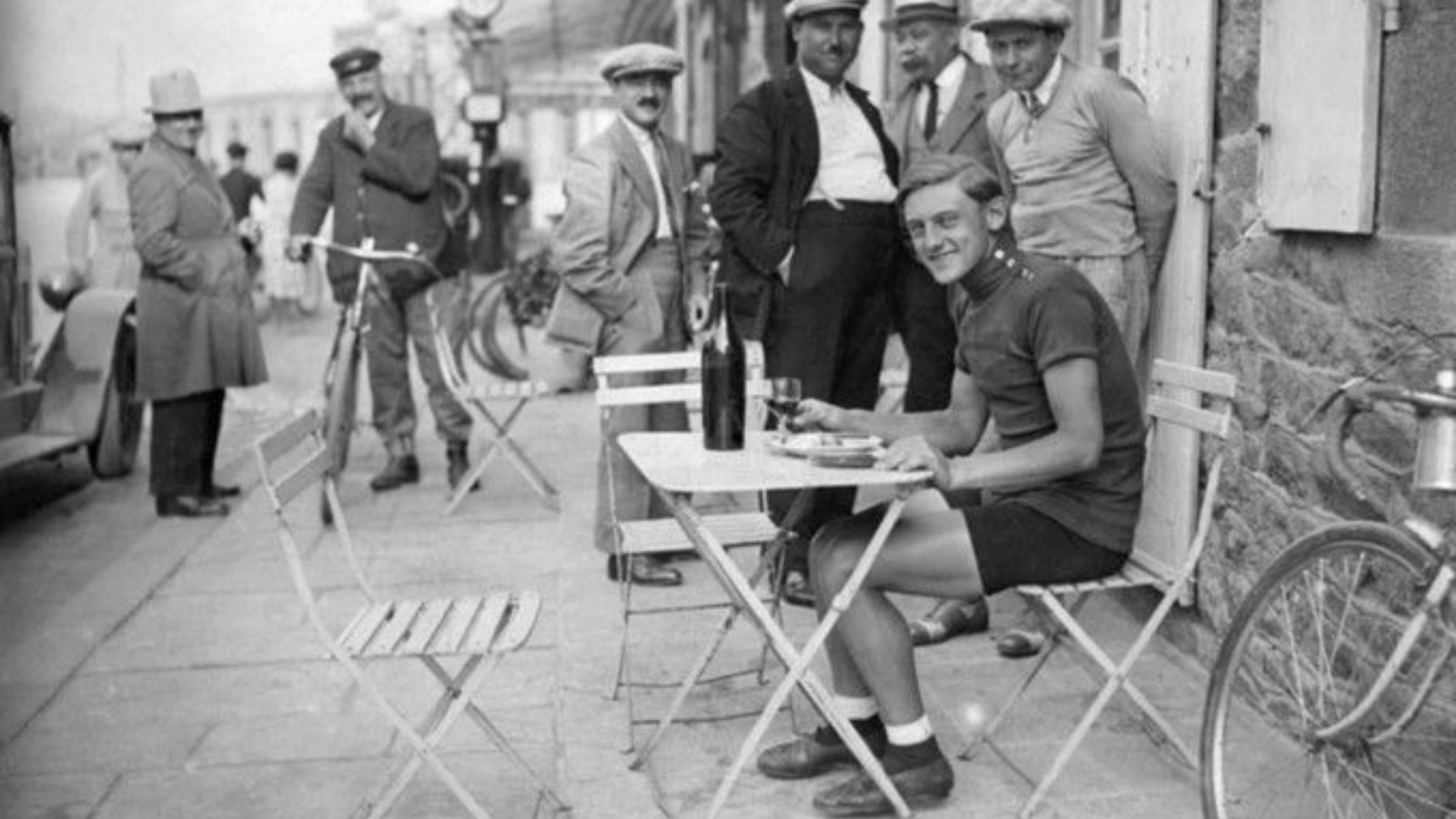 Max Bulla the first Austrian cyclist to wear the yellow jersey at the Tour de France sitting at a desk and smiling into the camera
