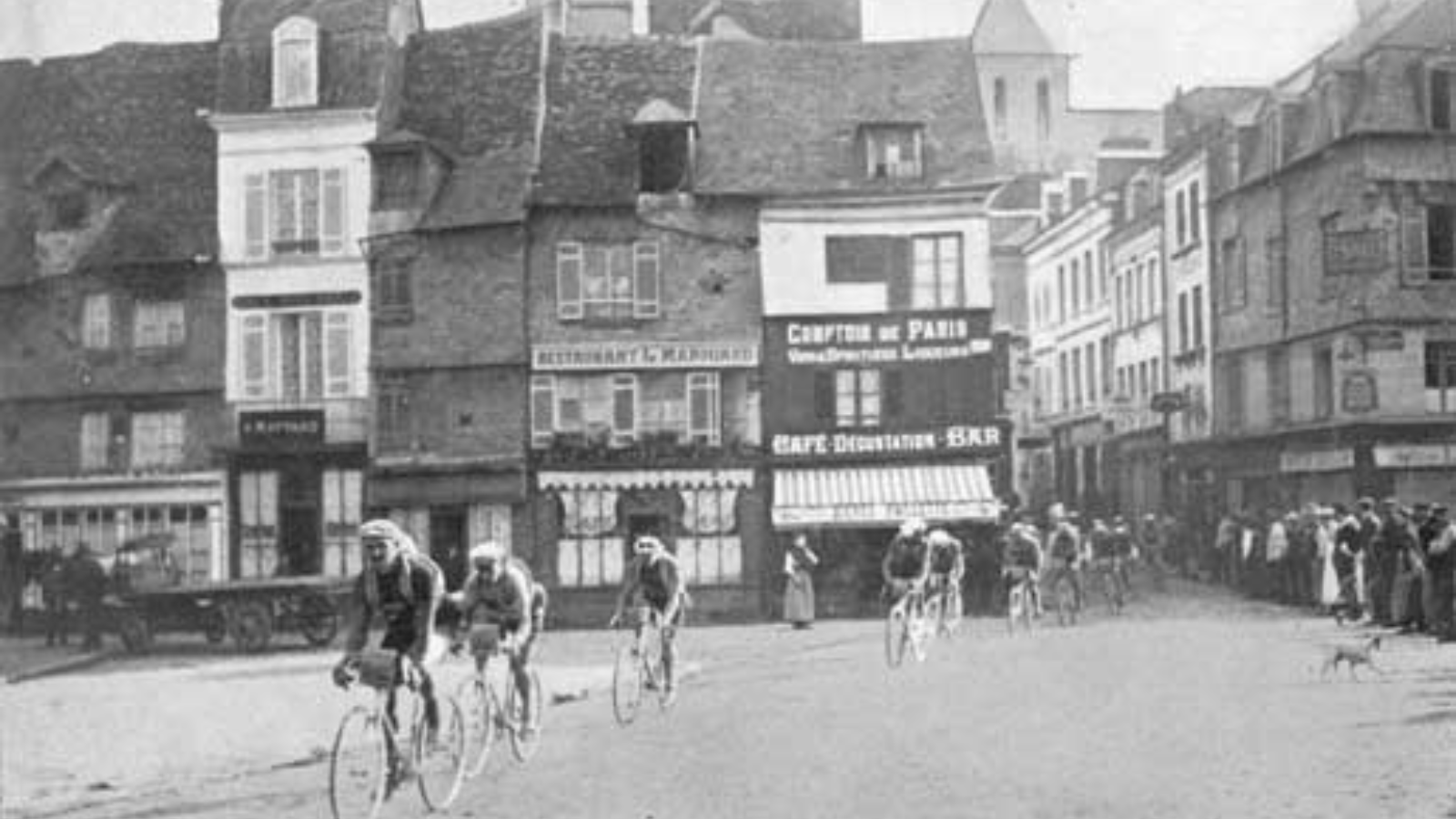 Cyclists crossing a town during the Tour de France in 1914