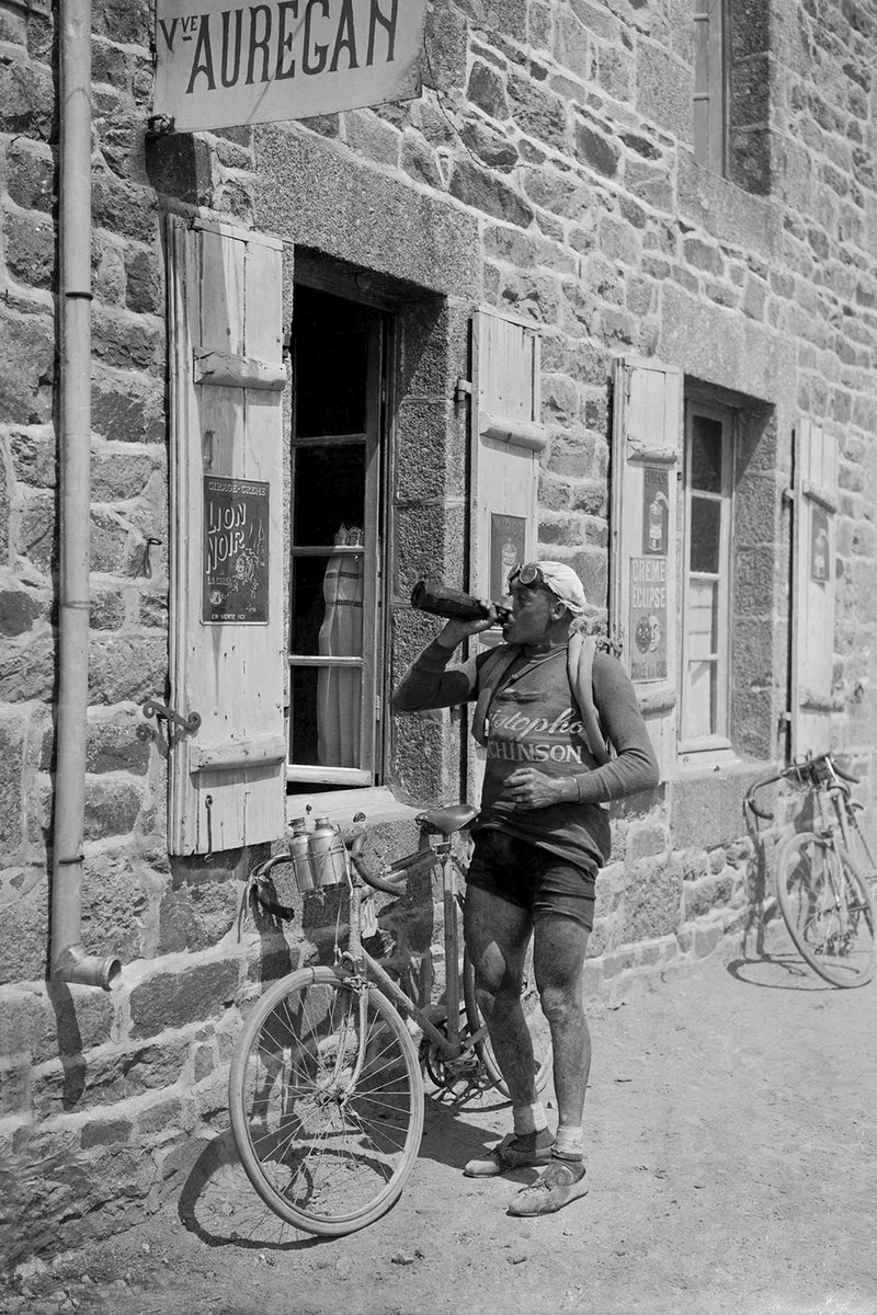 Victor Lenaers, a French cyclist drinks wine froma bottle during Tour de France 1921