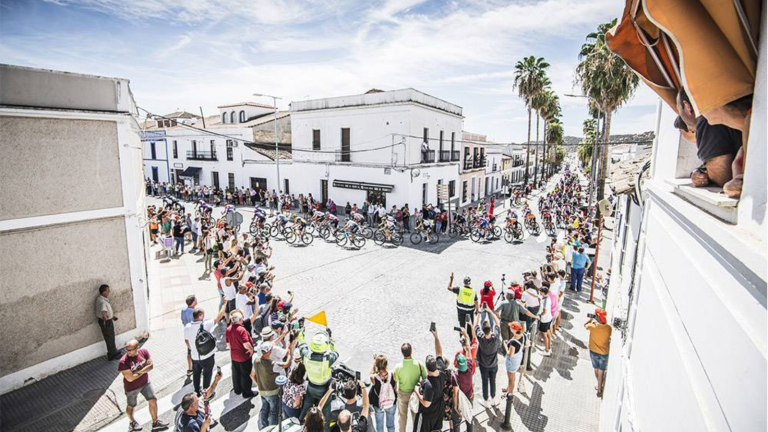 Scenic image with Spanish houses with white walls and the peloton of Vuelta a Espana