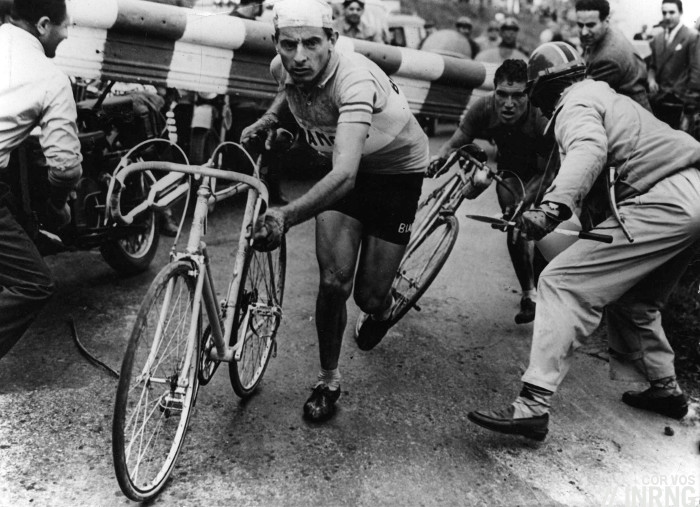 Fausto Coppi and a closing railway barrier. 