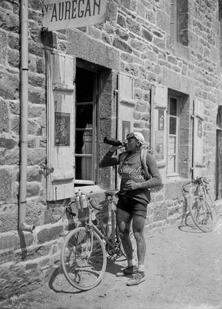 Leon Scieur drinking wine from a bottle at the Tour de France during the 1920s 