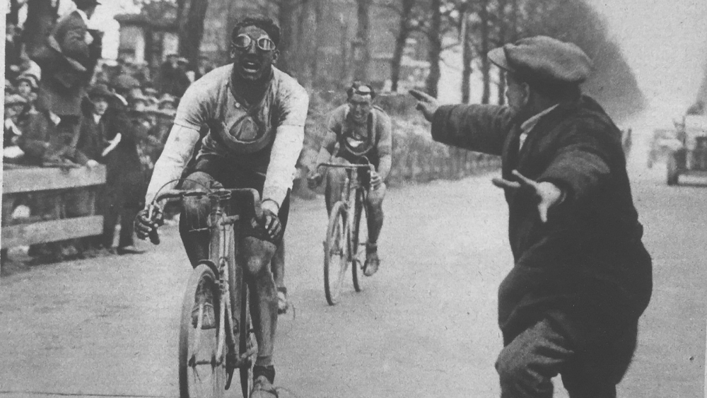 A black and white photo capturing the moment when French cyclist André Leducq crossing the finish line at Paris-Roubaix 1928 