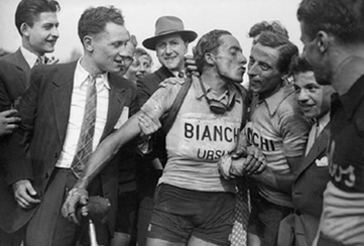 Italian cyclist Serse Coppi kisses his big brother, the great cycling legend Fausto Coppi after Paris-Roubaix 1949