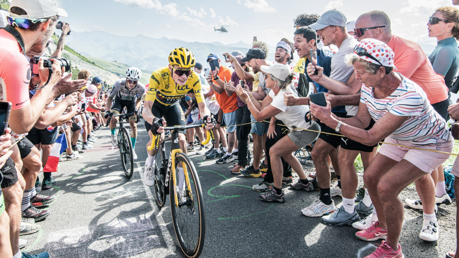 A moment in the mountains at Tour de France 2023, when Jonas Vingegaard in the yellow jersey is cheered by the crowd.