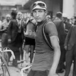Legendary Italian cyclist Gino Bartali standing in the cemter of the picture, several other riders behind him
